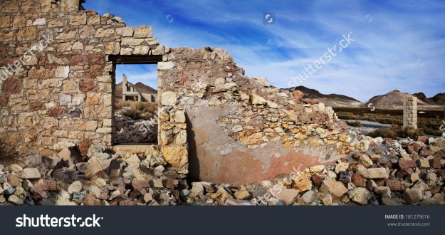 stock-photo-the-wall-and-window-of-a-crumbling-and-ruined-building-at-rhyolite-nevada-an-abandoned-town-near-181279616
